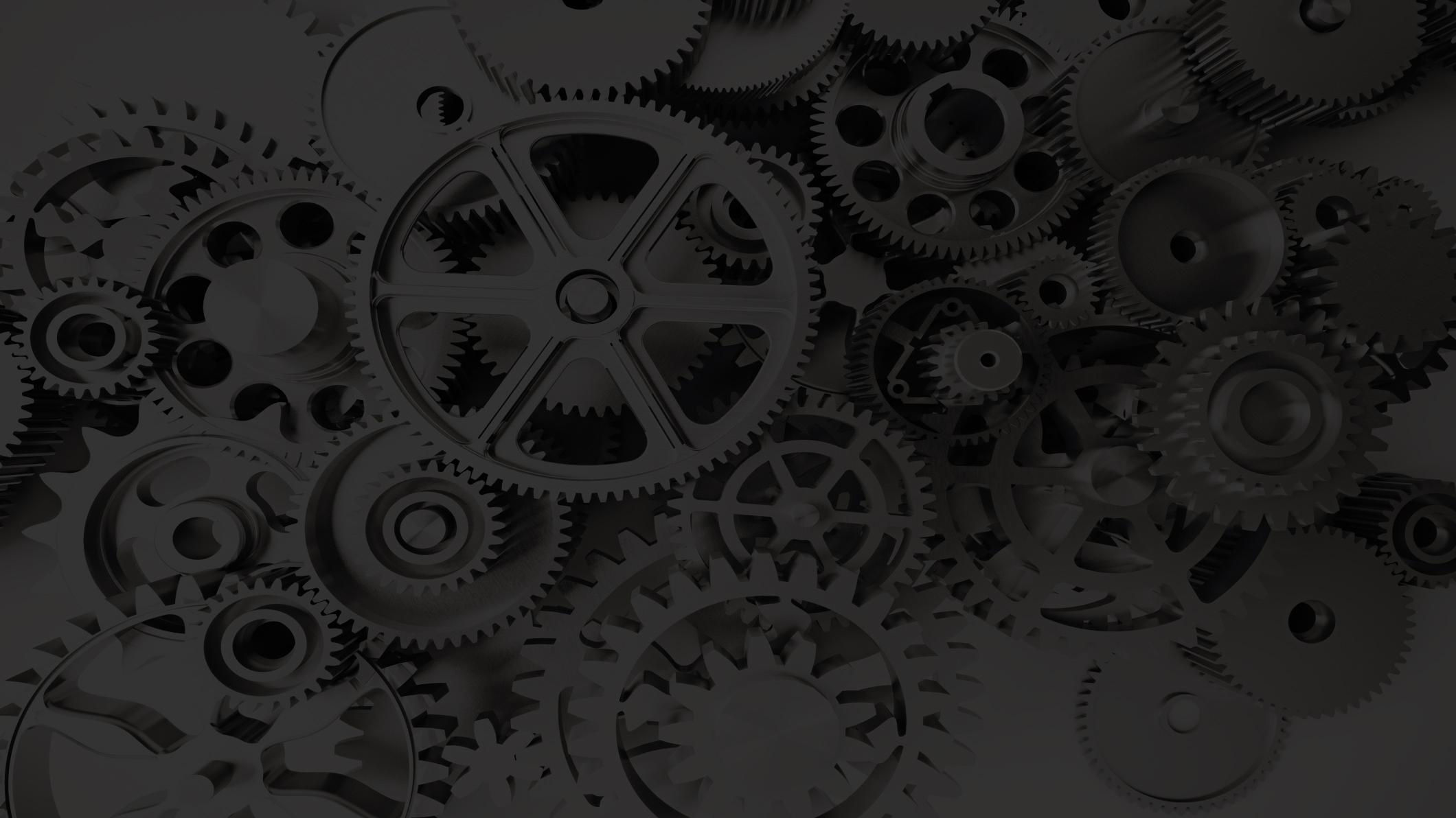 Dark monochrome close-up of interlocking mechanical gears, conveying an industrial, technical mood